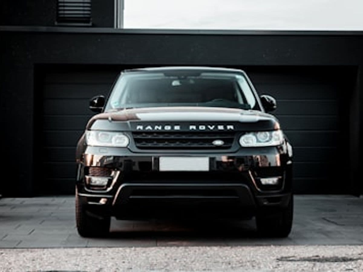 A black luxury SUV waiting at dusk